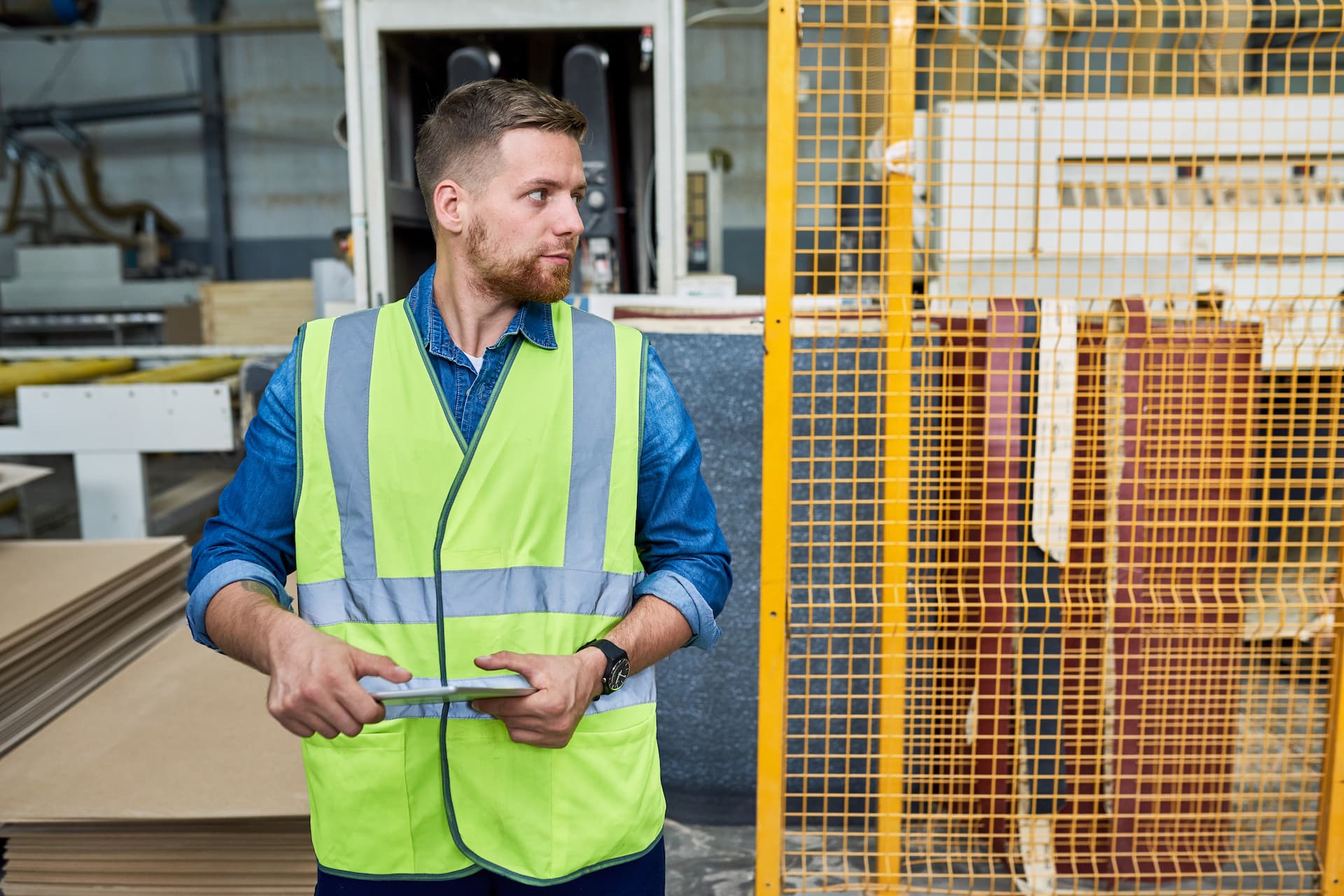 Factory worker focusing on their task in a busy workshop